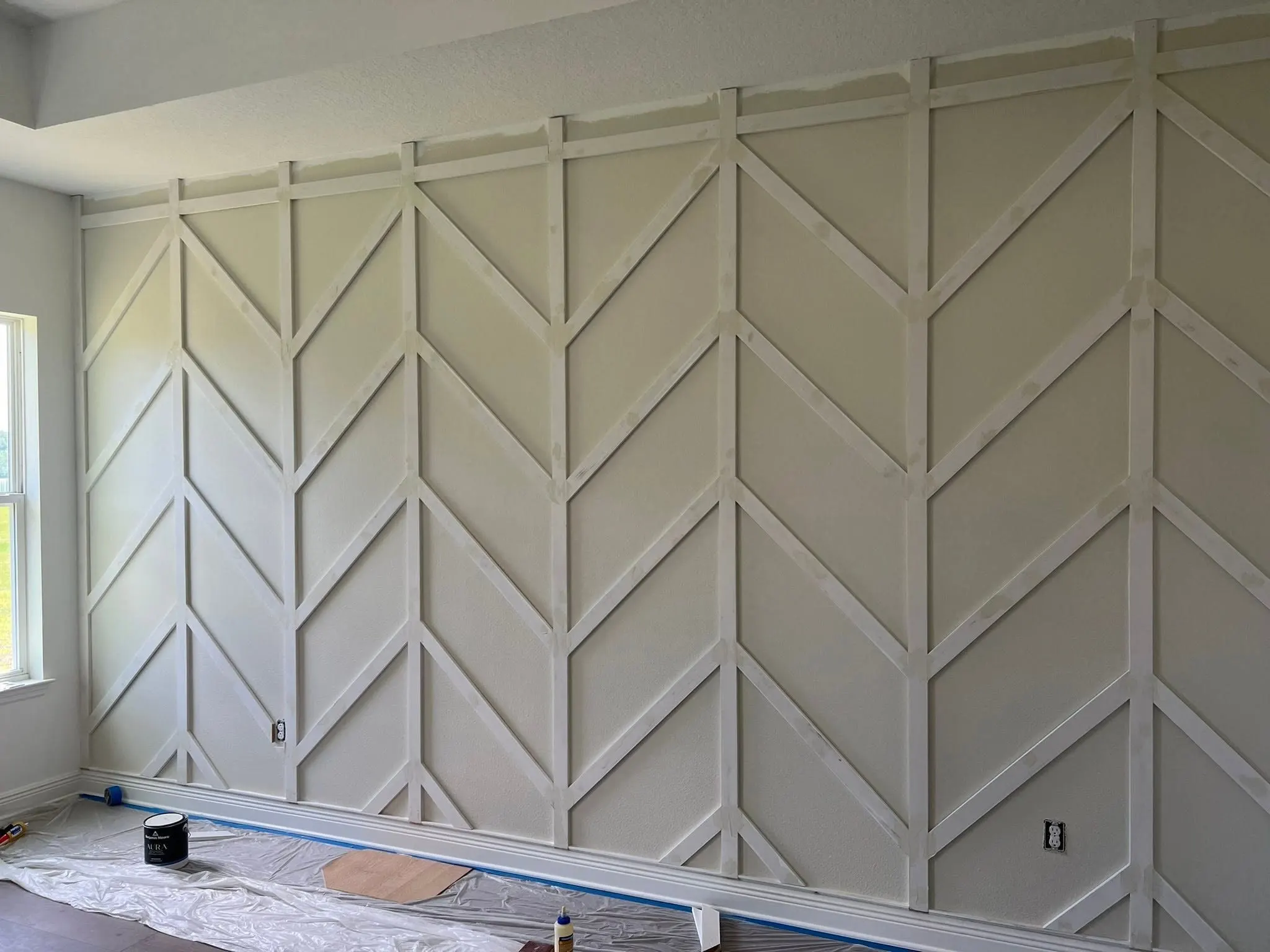 Chevron accent wall seen at an angle beside a window