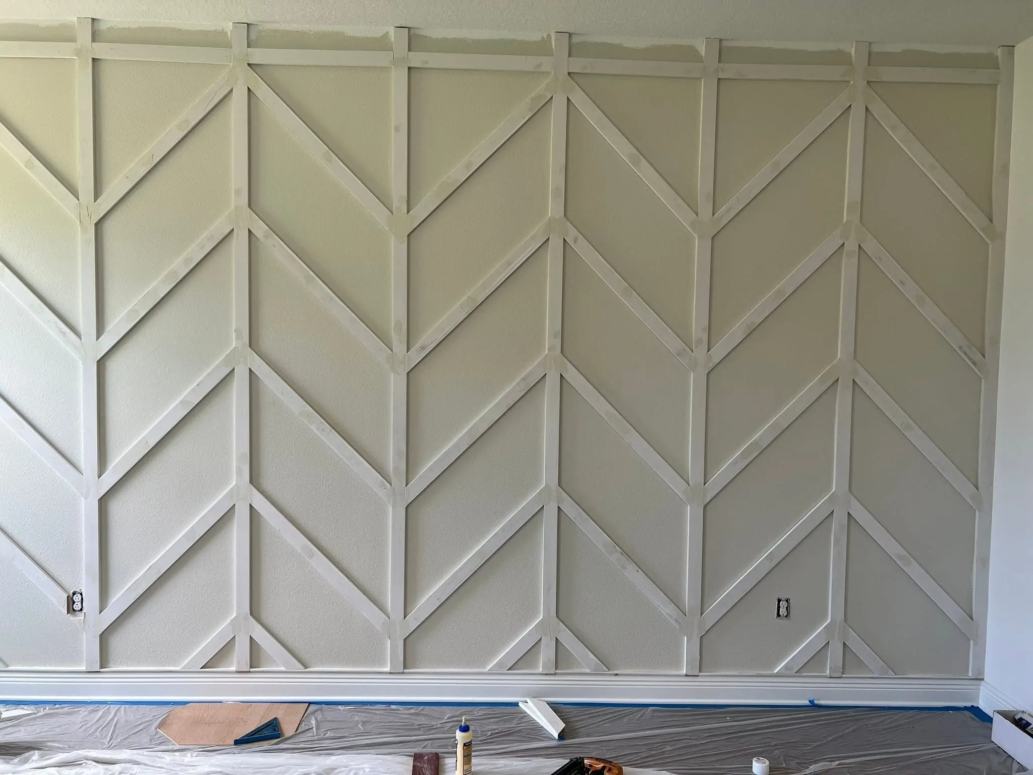 Full-height chevron accent wall in painted trim