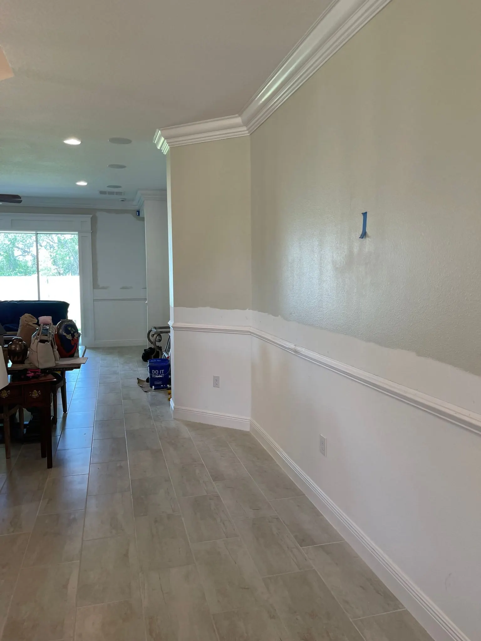 Hallway with chair rail over white wainscoting and crown molding above