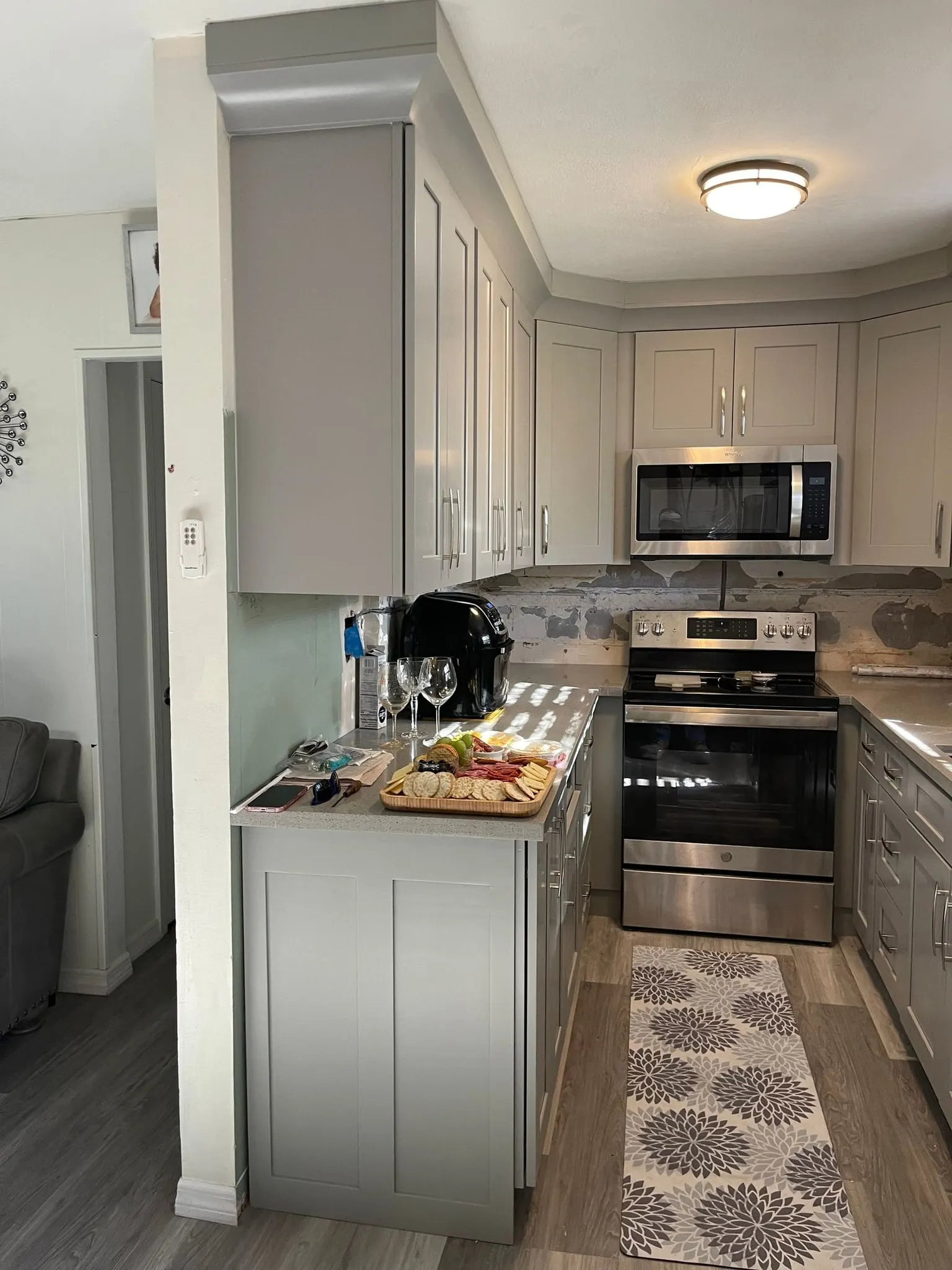 Gray shaker galley kitchen with stainless appliances
