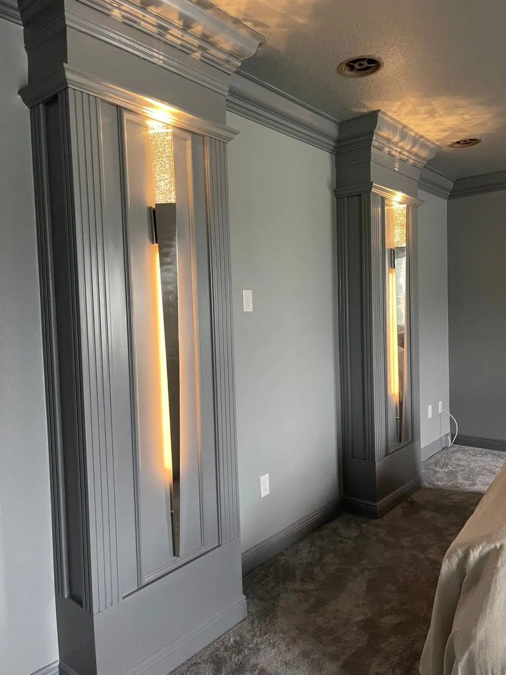 Gray paneled column with a recessed light strip in a media room