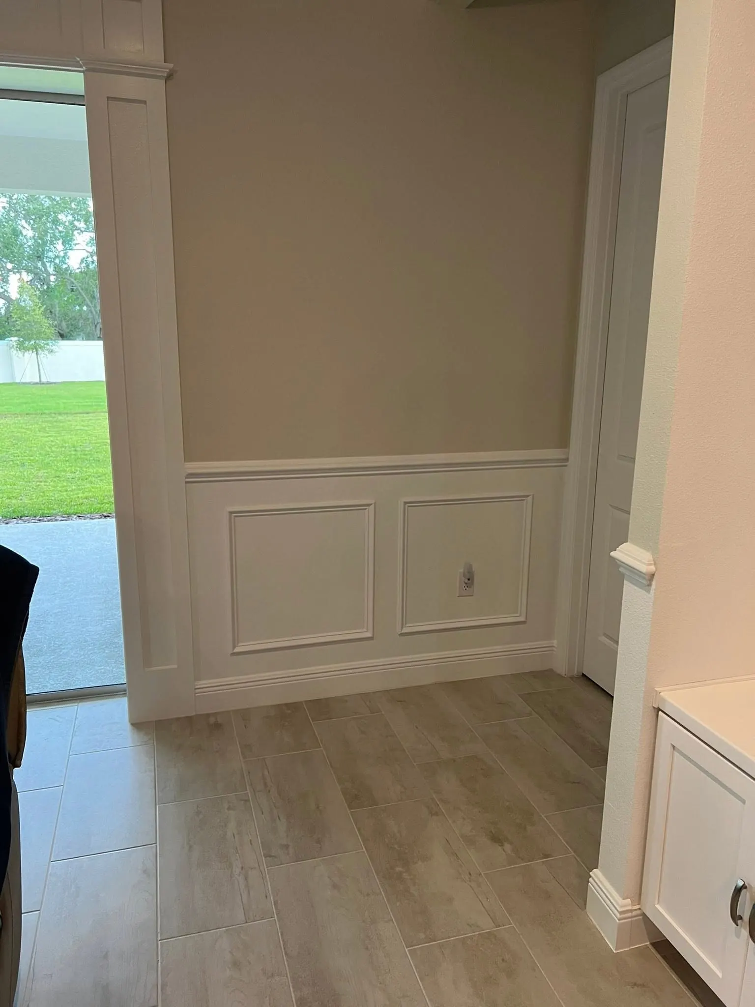 Picture-frame wainscoting panels below a chair rail