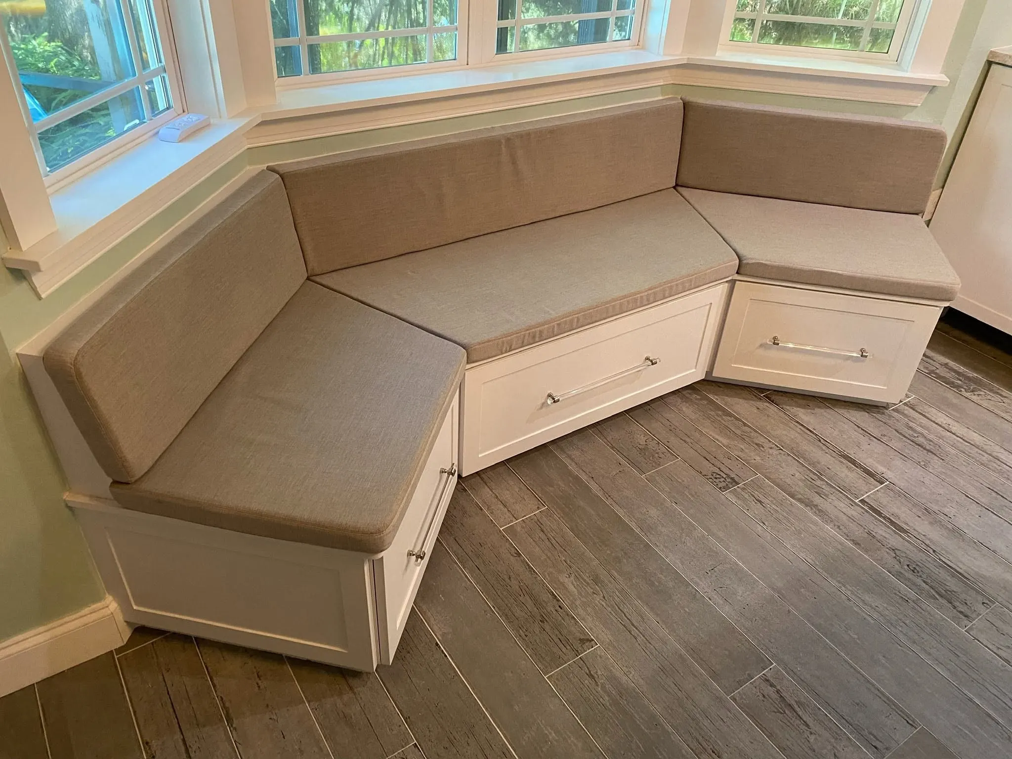 Bay window seat with drawer fronts along its base